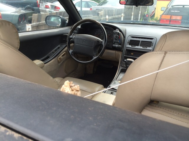 This poor car has been rained in many times through these holes in the convertible top.